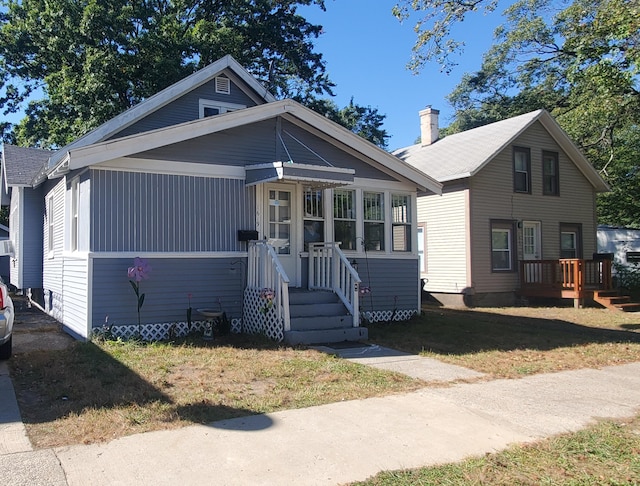 bungalow-style house with a front lawn