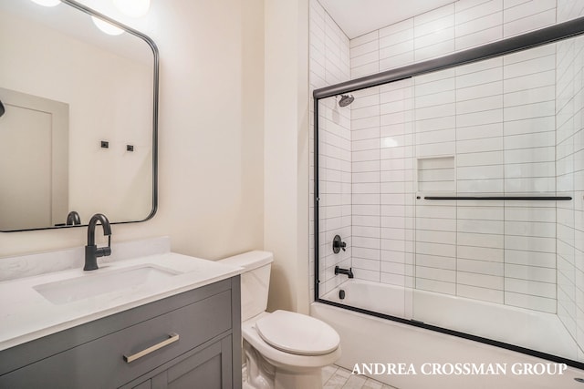 full bathroom with vanity, combined bath / shower with glass door, and toilet