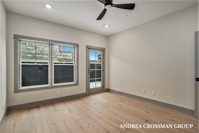 spare room featuring ceiling fan and light wood-type flooring