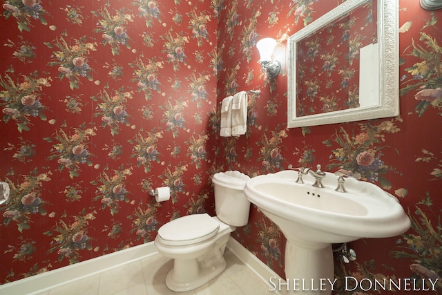 bathroom with toilet and tile patterned floors