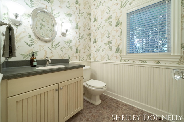 bathroom featuring toilet, tile patterned floors, and vanity