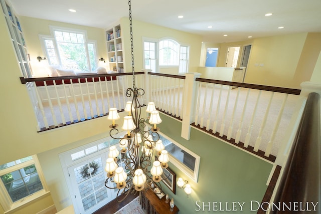 stairway featuring an inviting chandelier