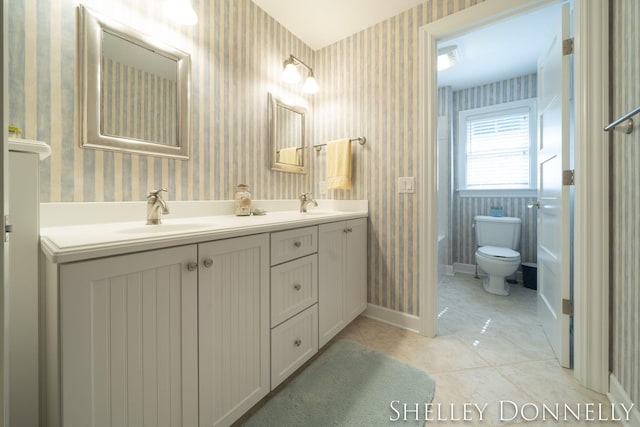 bathroom featuring vanity, toilet, and tile patterned flooring