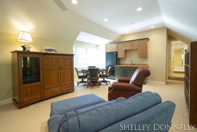 living room with light colored carpet, sink, and vaulted ceiling