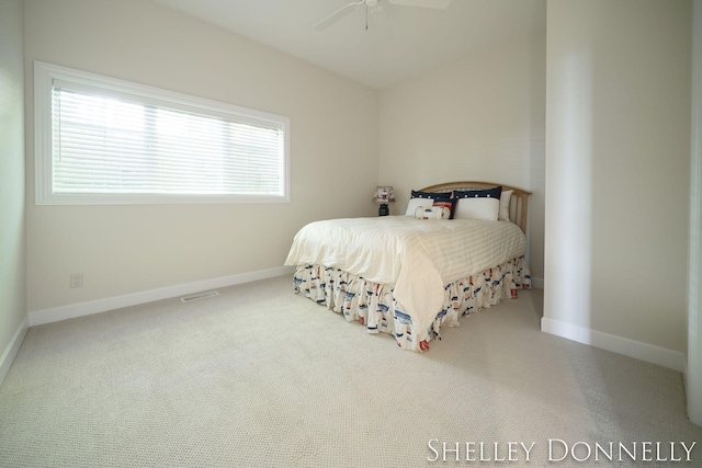 carpeted bedroom with multiple windows and ceiling fan