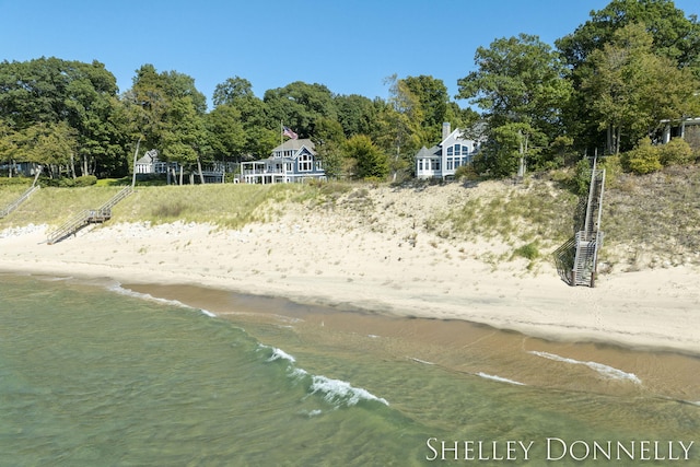 view of community featuring a water view and a view of the beach