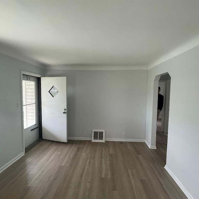 unfurnished room with dark hardwood / wood-style flooring