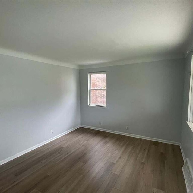 unfurnished room featuring dark wood-type flooring