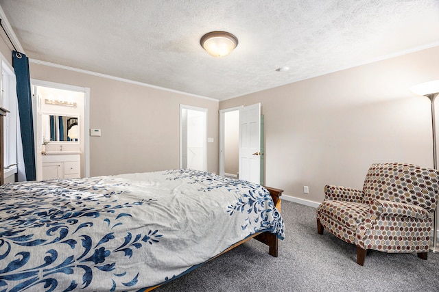 carpeted bedroom featuring a textured ceiling, ornamental molding, ensuite bathroom, and baseboards