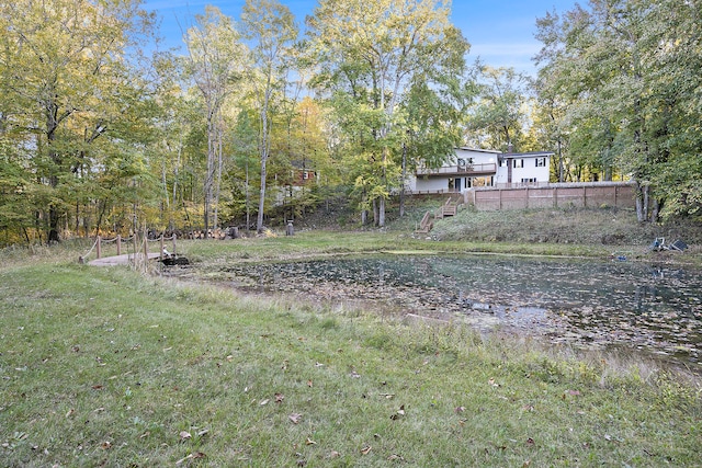 view of yard with a water view and stairs