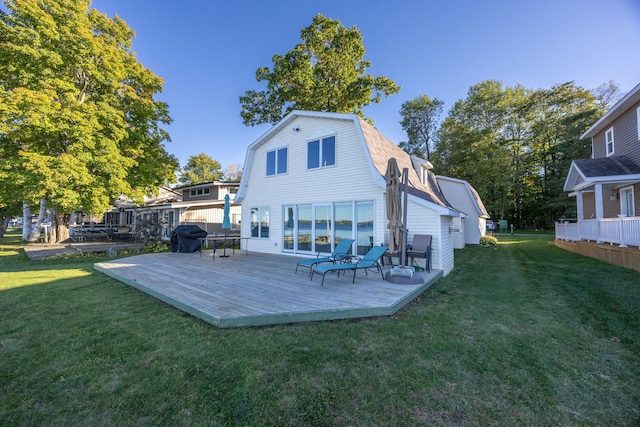 rear view of house featuring a wooden deck and a yard