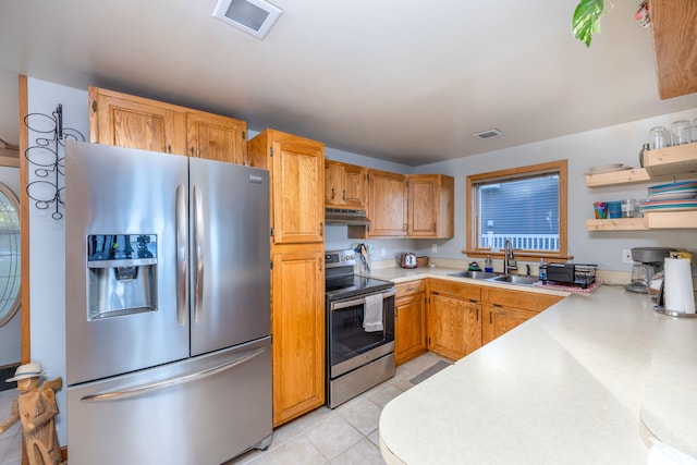 kitchen with light tile patterned flooring, stainless steel appliances, and sink