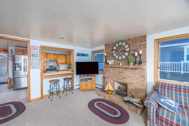 carpeted living room with a fireplace