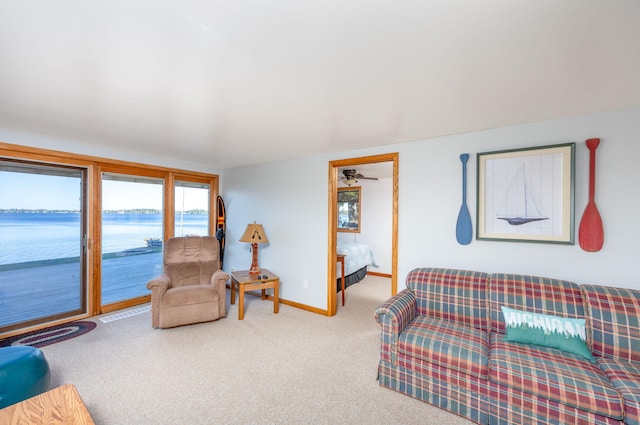 living room featuring carpet flooring and a water view