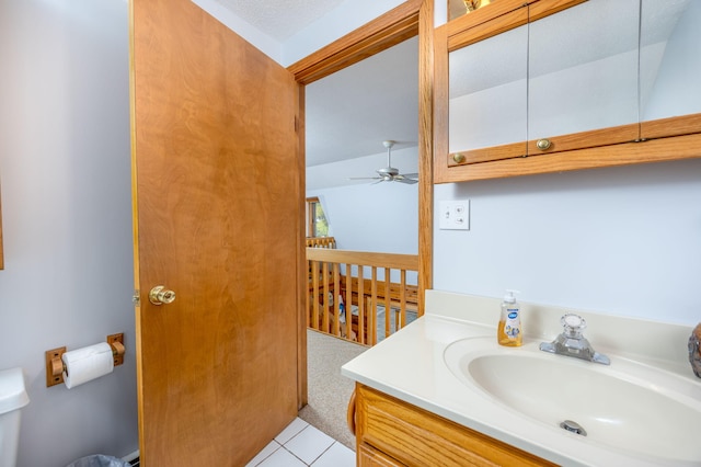 bathroom featuring ceiling fan, vanity, a textured ceiling, tile patterned floors, and toilet