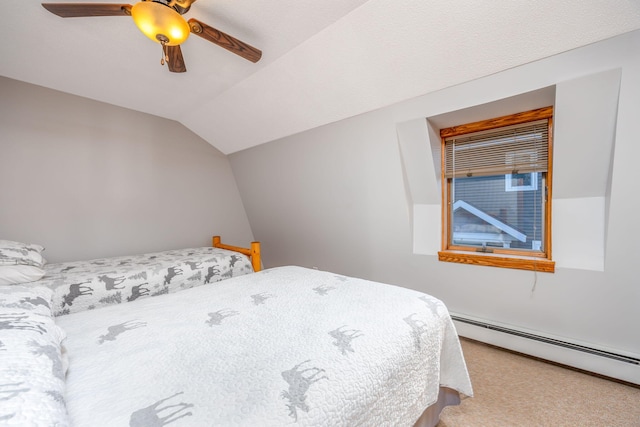 carpeted bedroom featuring vaulted ceiling, a baseboard heating unit, and ceiling fan