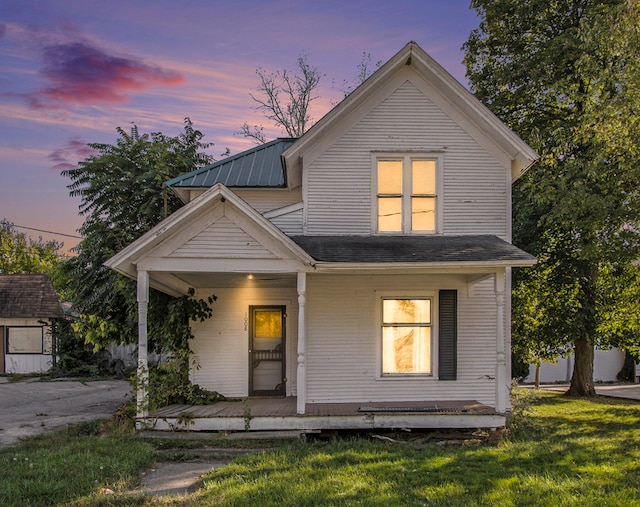 view of front facade featuring a lawn and a porch