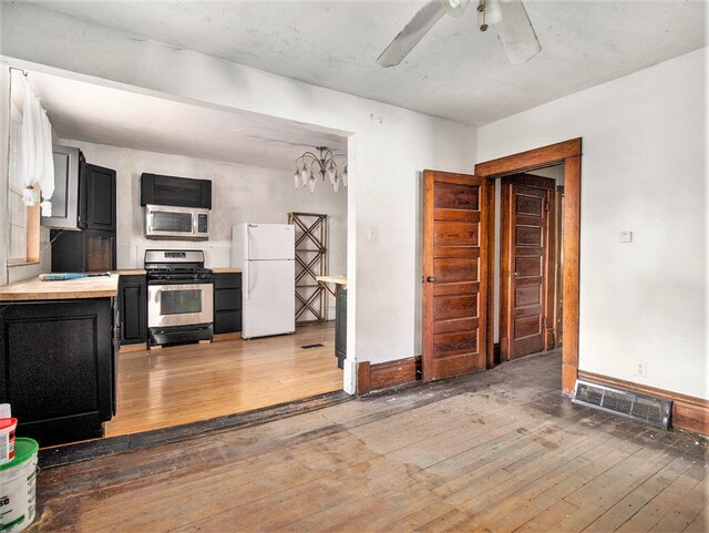 kitchen featuring hardwood / wood-style floors, stainless steel appliances, and ceiling fan