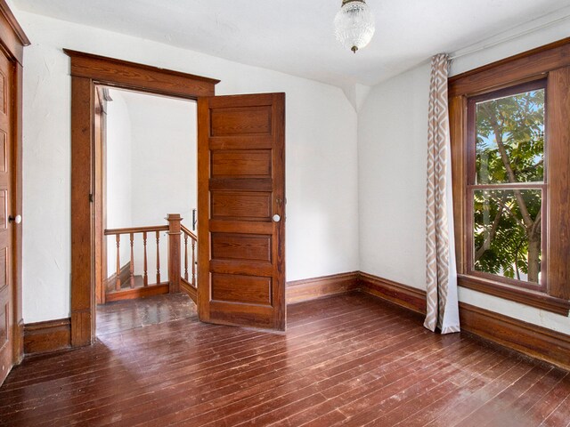 spare room featuring dark wood-type flooring