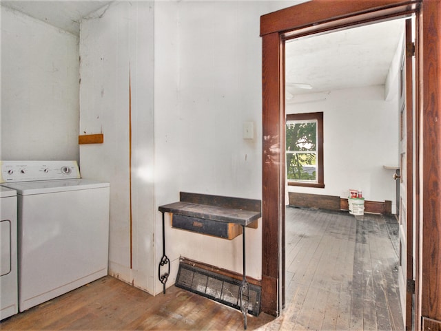 laundry room featuring hardwood / wood-style flooring and washer and clothes dryer