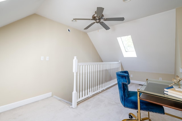 office featuring lofted ceiling with skylight and light colored carpet