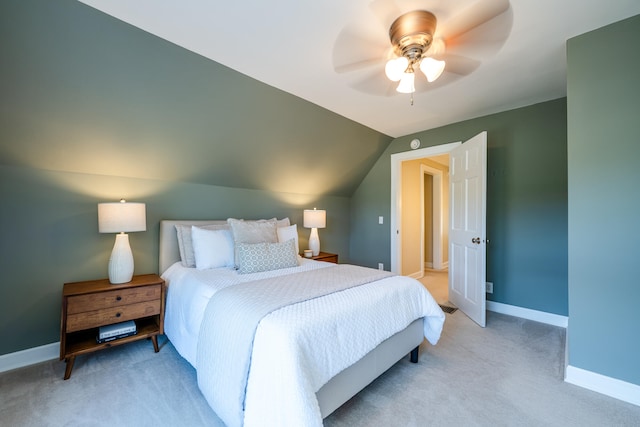 bedroom featuring light carpet, vaulted ceiling, and ceiling fan