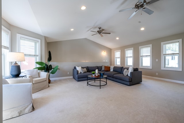 carpeted living room featuring ceiling fan and lofted ceiling