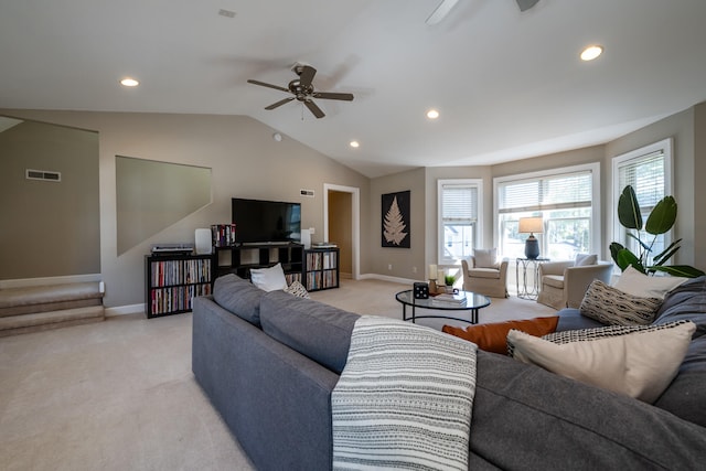 living room featuring light carpet, ceiling fan, and vaulted ceiling