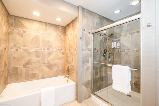 bathroom featuring plus walk in shower and tile patterned floors