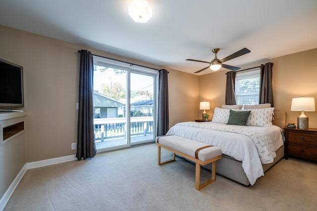 carpeted bedroom featuring multiple windows, ceiling fan, and access to outside