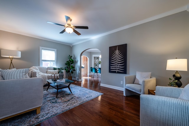 living room with ornamental molding, dark hardwood / wood-style flooring, and ceiling fan