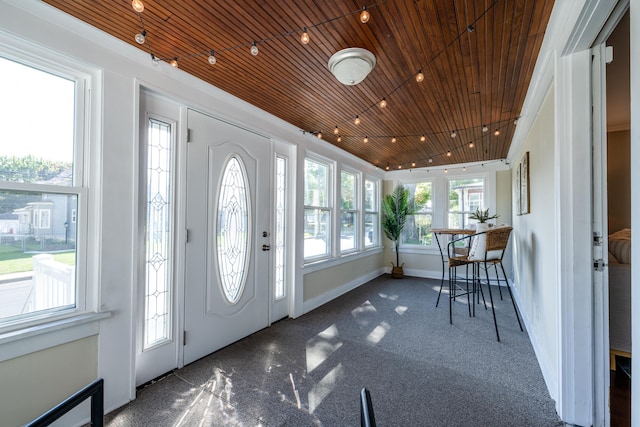 carpeted foyer featuring wooden ceiling