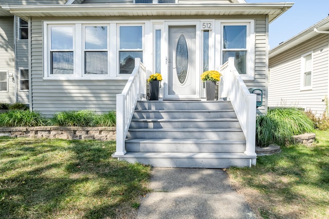 doorway to property featuring a lawn