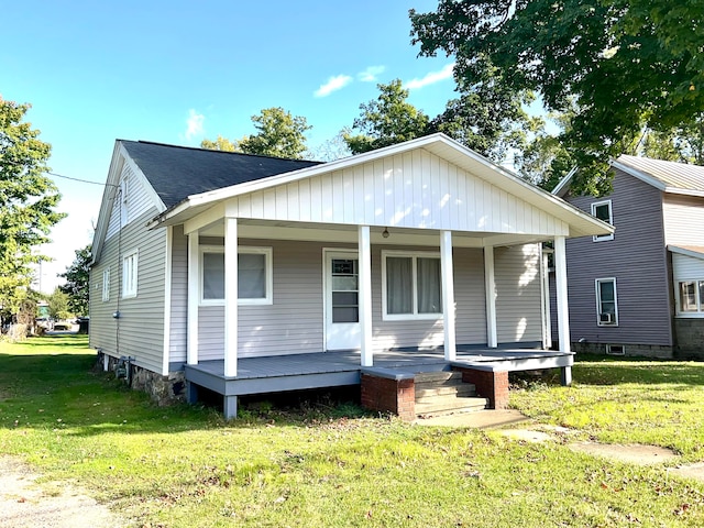 bungalow-style house with a porch and a front yard