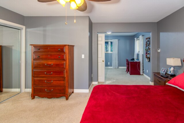 carpeted bedroom featuring ceiling fan and a closet