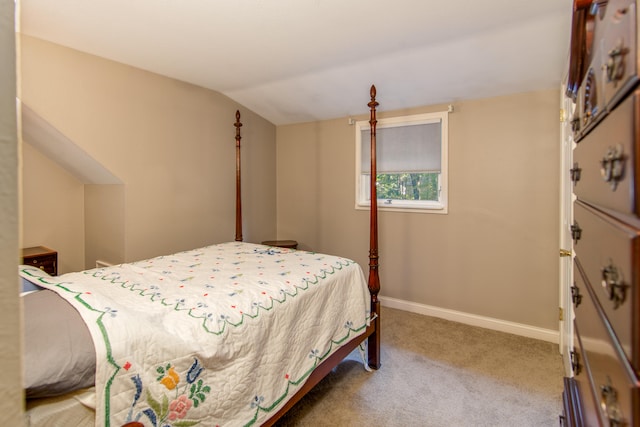 bedroom with light carpet and vaulted ceiling