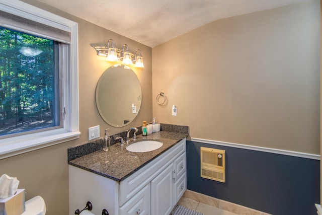 bathroom with lofted ceiling, vanity, tile patterned flooring, plenty of natural light, and toilet