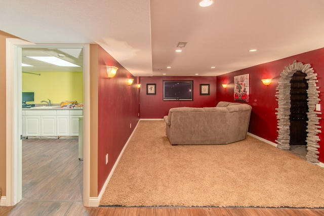 home theater with sink and hardwood / wood-style floors