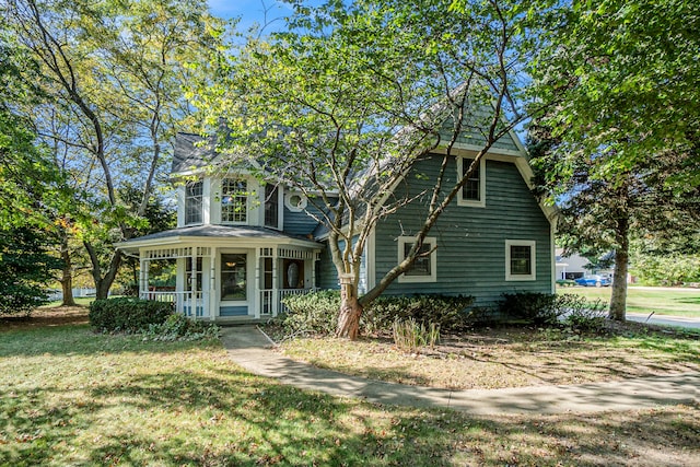 view of front of home featuring covered porch and a front yard