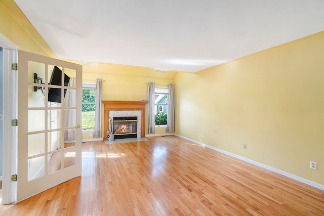 unfurnished living room featuring light hardwood / wood-style flooring and a premium fireplace