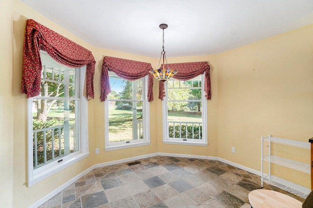 unfurnished dining area with a chandelier