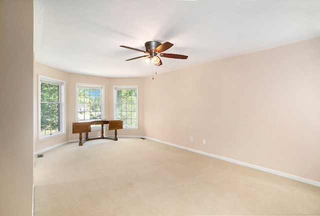 carpeted spare room with ceiling fan