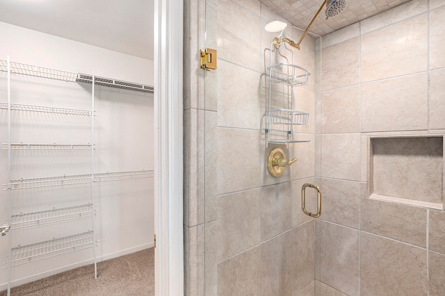 bathroom featuring a shower with door