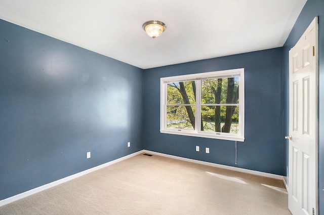 empty room featuring light carpet