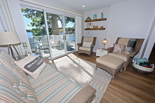 living room with wood-type flooring and a water view