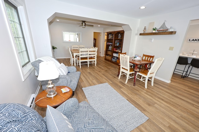 living room featuring ceiling fan and light wood-type flooring