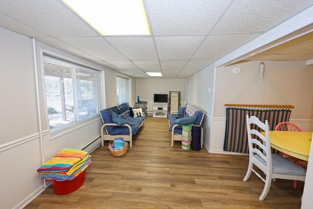 interior space featuring hardwood / wood-style flooring and a drop ceiling