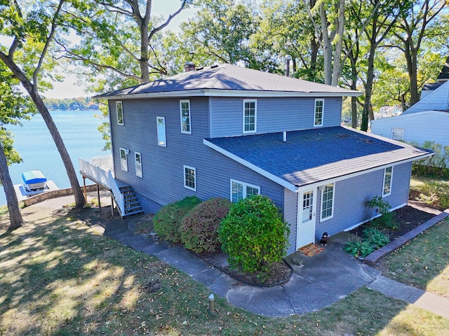 view of home's exterior with a water view