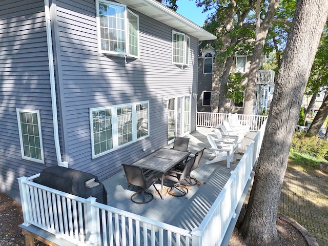 back of property featuring a wooden deck