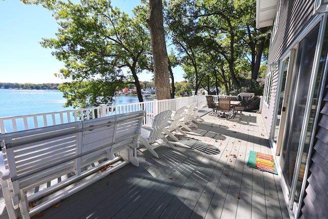 wooden deck featuring a water view